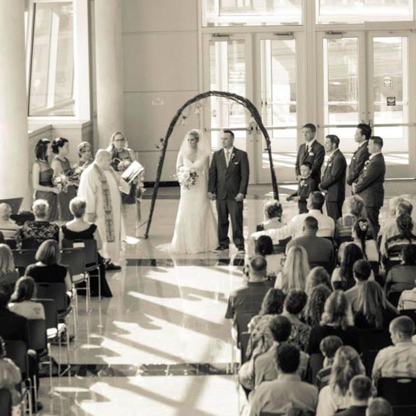 A black and white image of a wedding ceremony in the Atrium space.