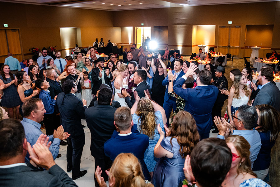 A newly married couple dances their first dance at their reception.