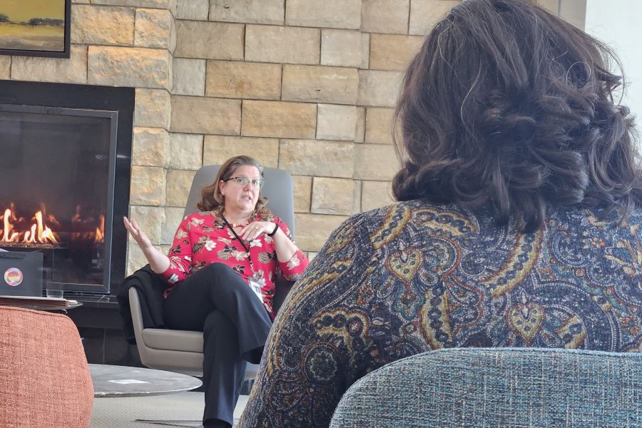 Educator discussing with a learner in a fireside chat setting