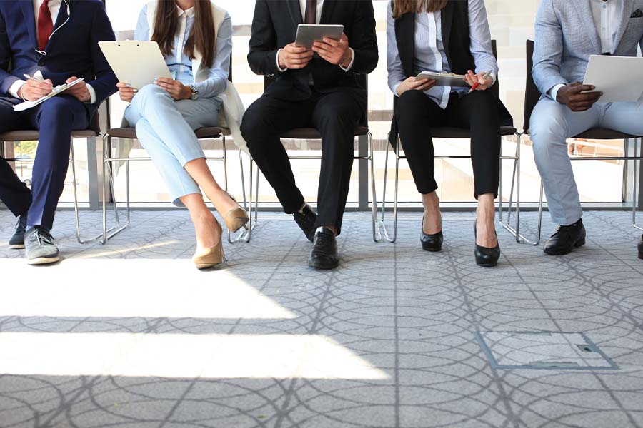 men and women waiting for an interview