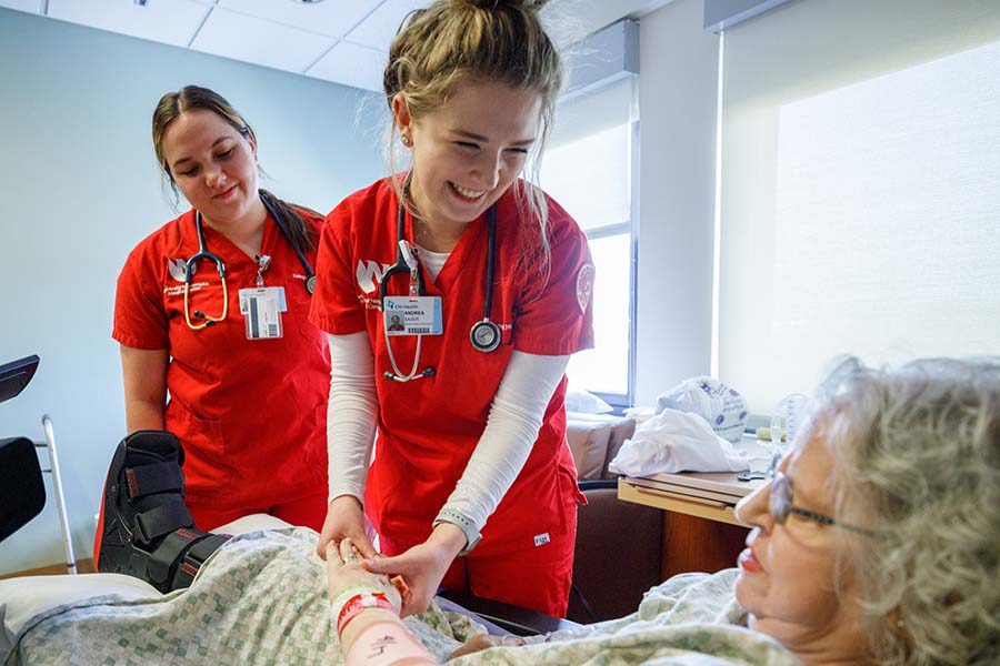 students visit with patient