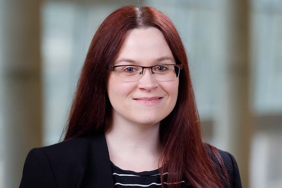 woman with long brown hair and glasses