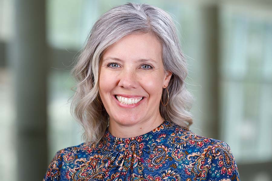 woman in floral shirt smiling