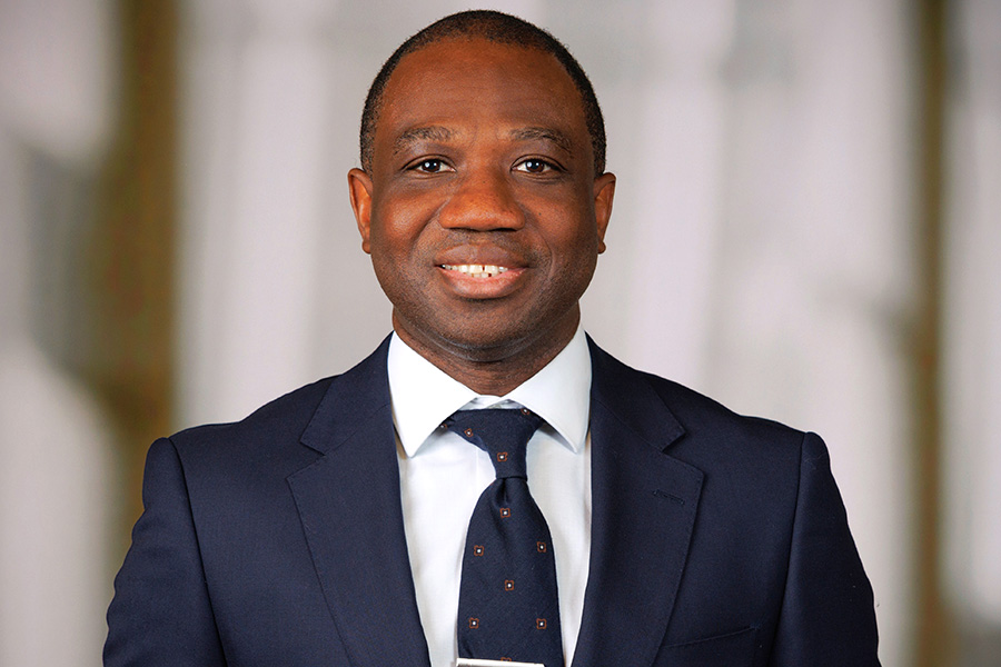 man in blue suit with white shirt and blue tie