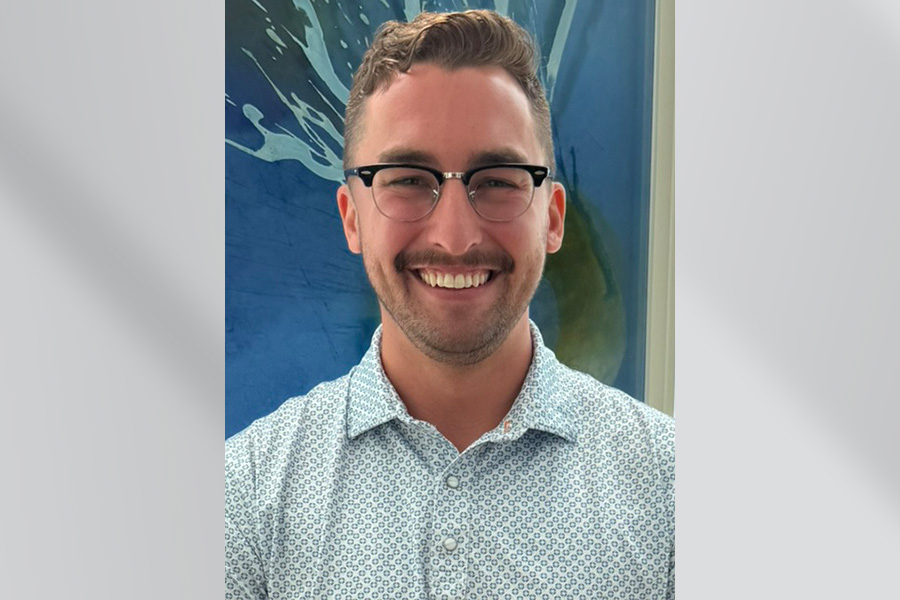 man with glasses and blue polo shirt