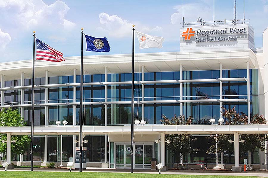 large medical building with signage that says Regional West Medical Center and three flagpoles in front