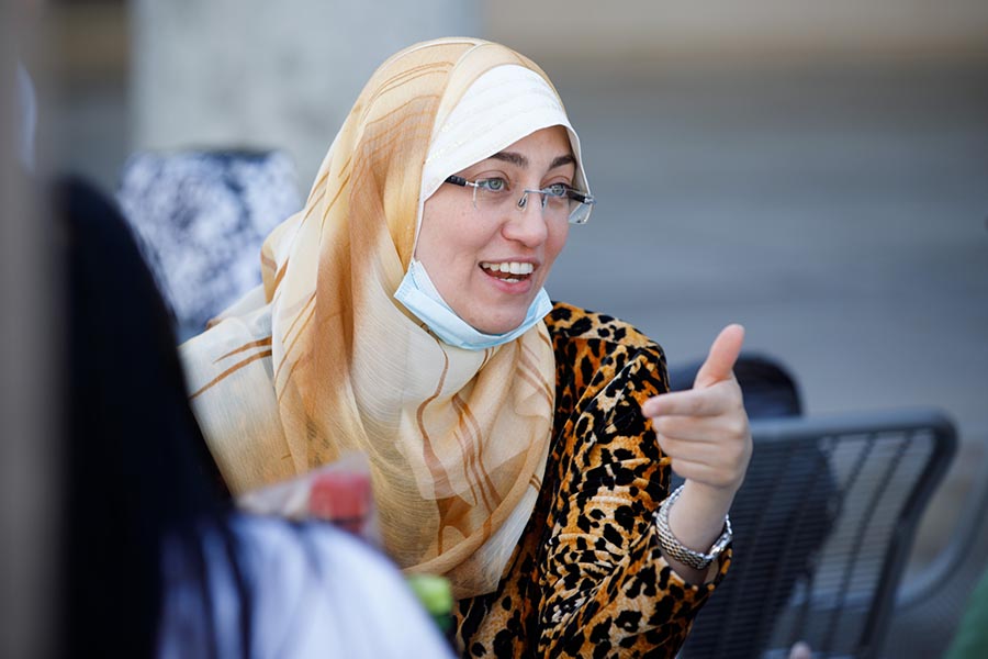 An international student at UNMC talks with classmates.