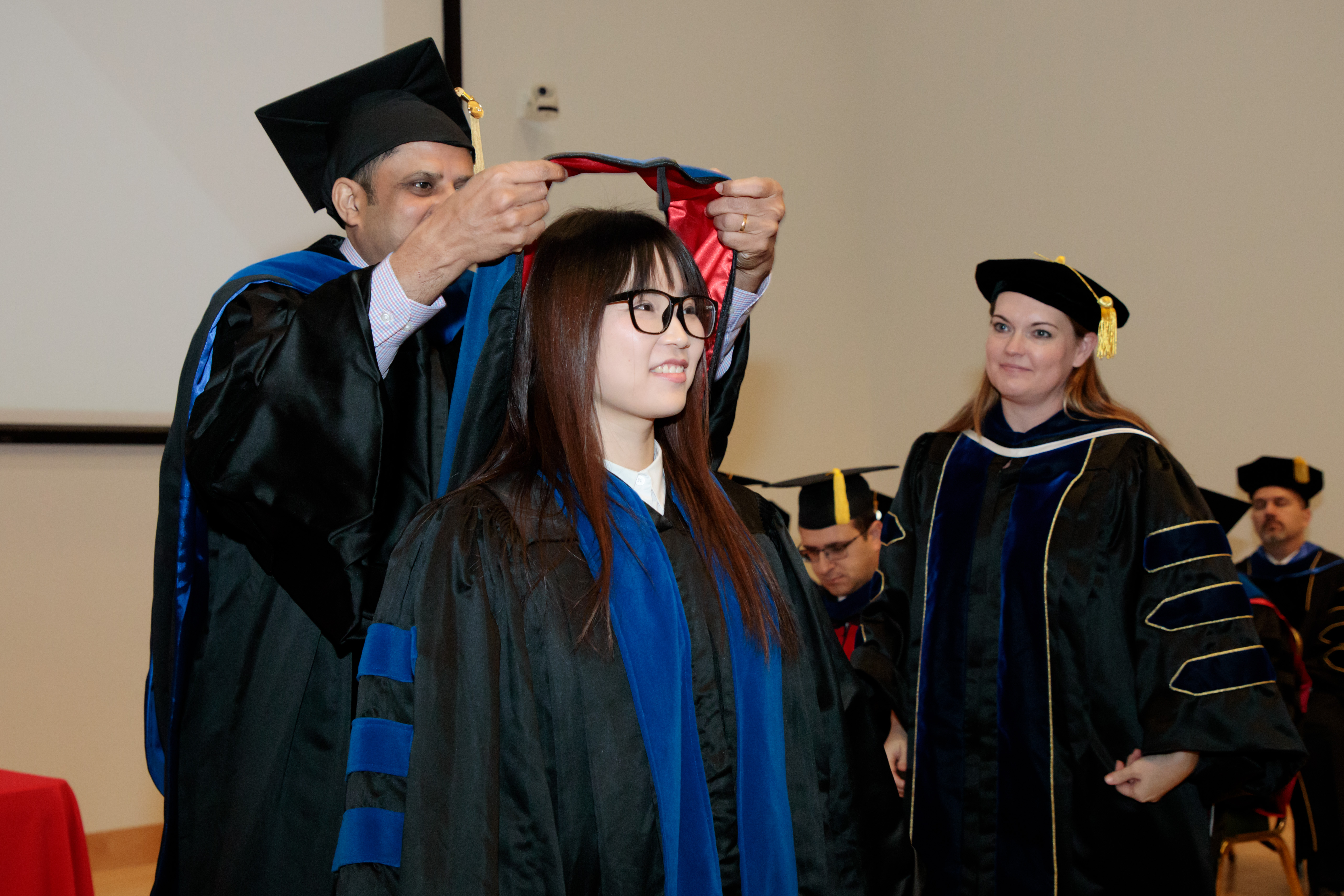 A student receives a graduation sash