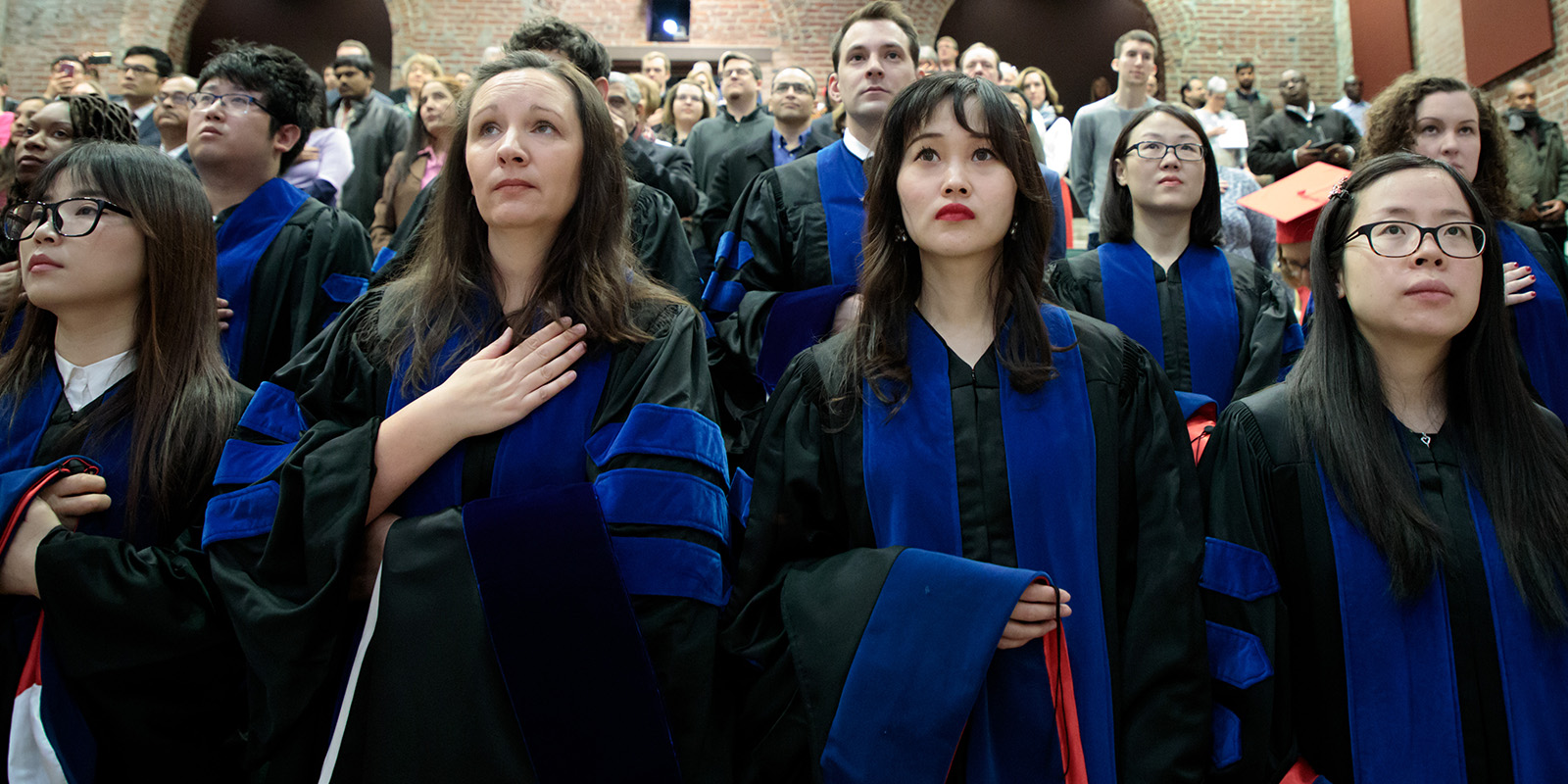 Graduates standing during convocation ceremony