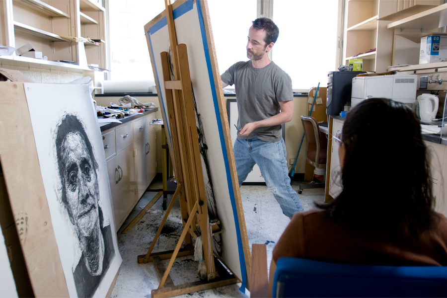Mark Gilbert, PhD, works on artwork in his studio