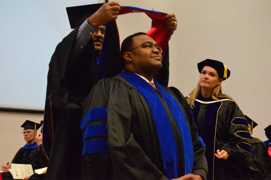 A male student receives his stole during a graduation ceremony