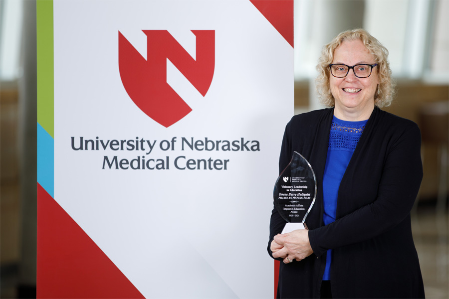 Teresa Barry Hultquist, PhD, displays a teaching award.