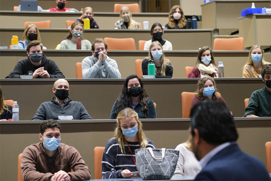 Rows of students attend a seminar in a lecture hall