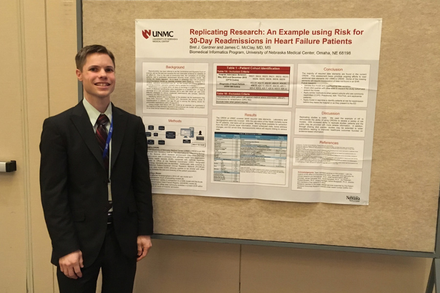 Student Bret Gardner presents a research poster at a conference