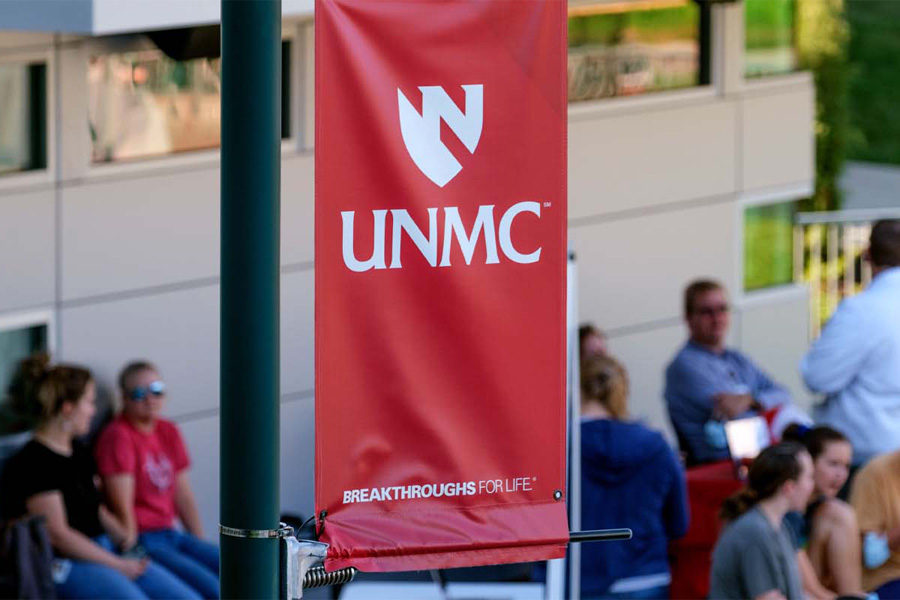 An outdoor banner with the UNMC logo