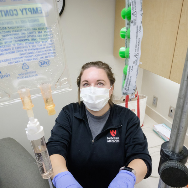 A nurse works in a patient room