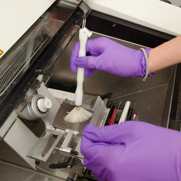A researcher cleans lab equipment
