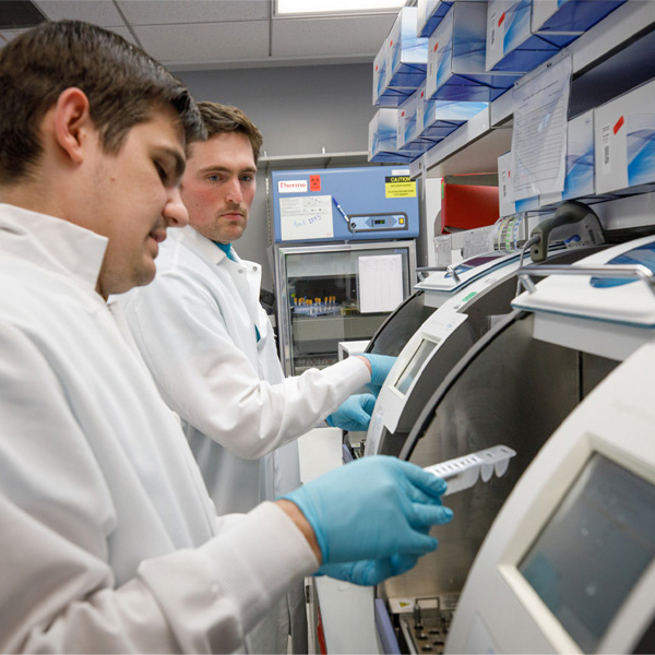 Two students work in a lab