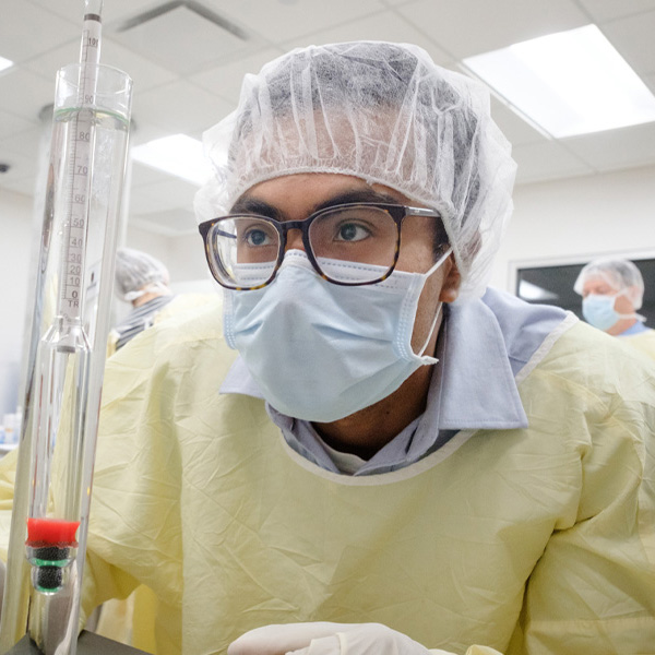 A student in PPE works in a lab