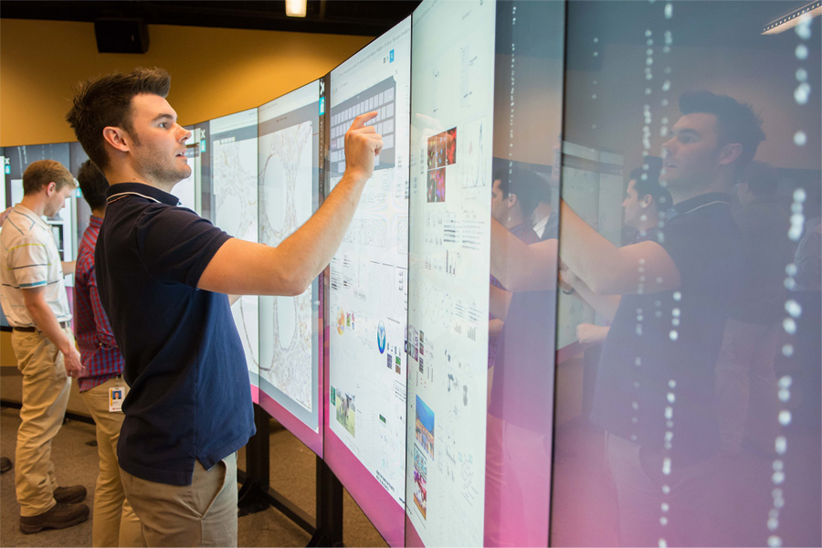 A student interacts with a large digital display