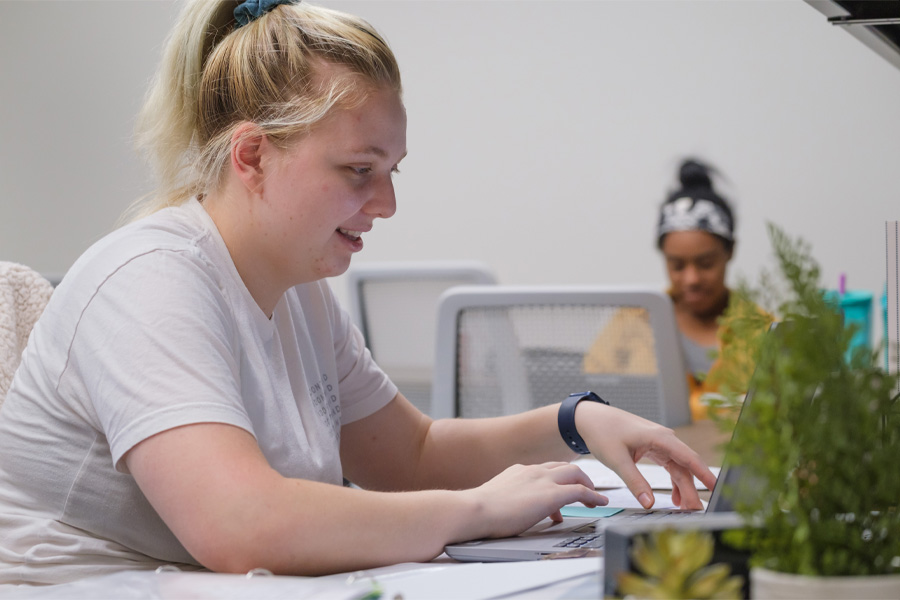 A student works at a laptop