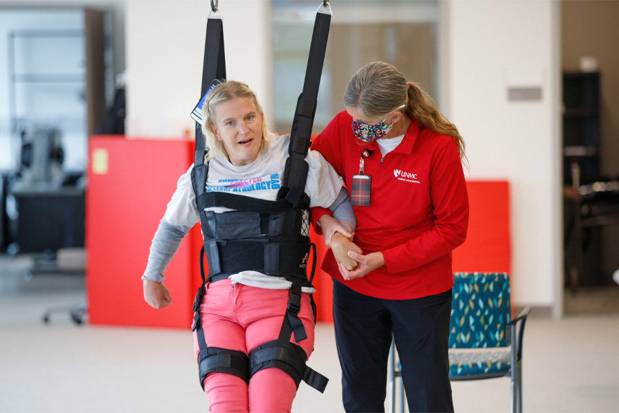 A staff member works with an MMI patient