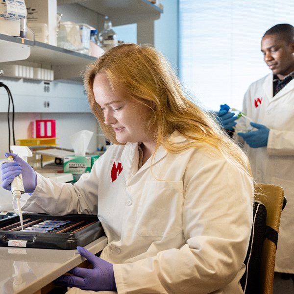 Female student performs research in a lab