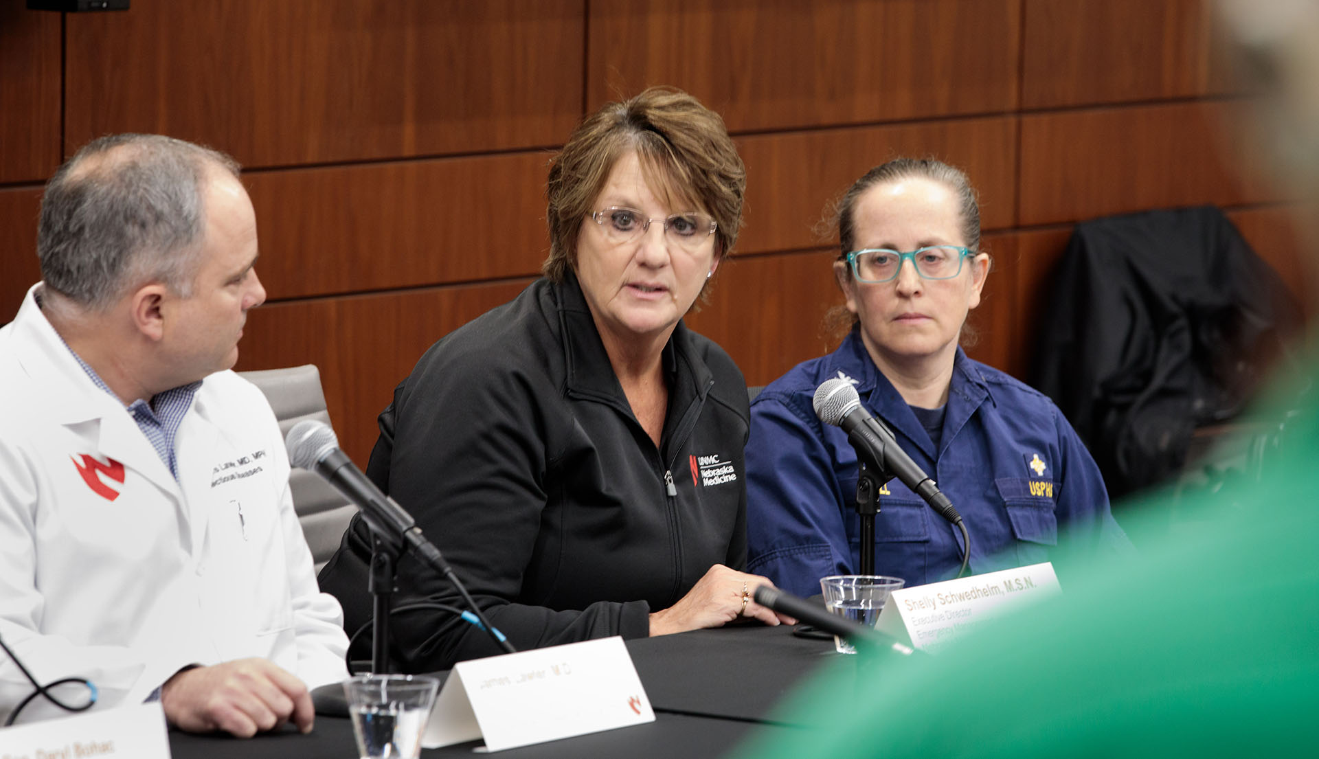 Shelly Schwedhelm, executive director of emergency management and clinical operations at the Global Center for Health Security, addresses a press conference in February 2020 about the emerging coronavirus pandemic. At left is James Lawler, MD, executive director of international programs and innovation for the GCHS.