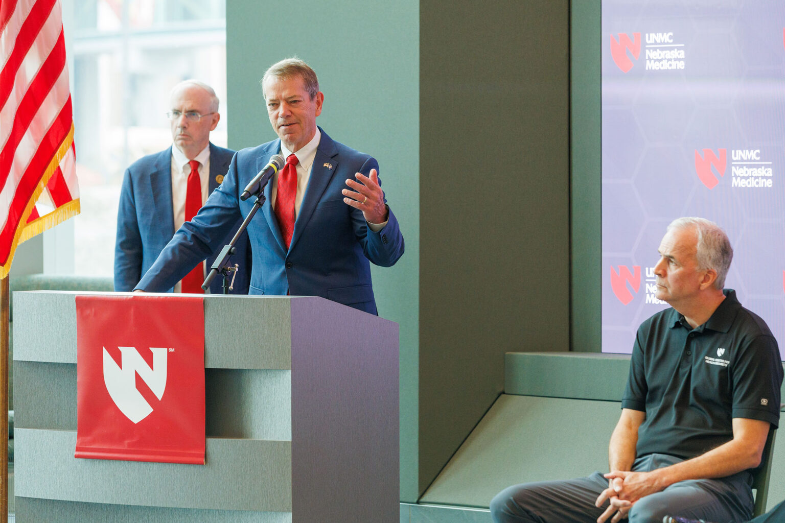 Gov. Jim Pillen speaking at a press conference to give update on the guests in the National Quarantine Unit at UNMC, along with NU President Jeffrey P. Gold, MD, at left, and Michael Wadman, MD, medical director of the National Quarantine Unit.