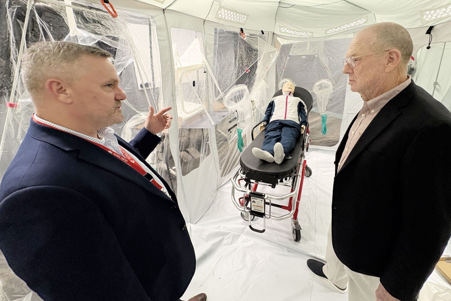 Retired Lt. Gen. James Roudebush (at right), MD, receives a tour of the GCHS and Training Simulation and Quarantine Center.