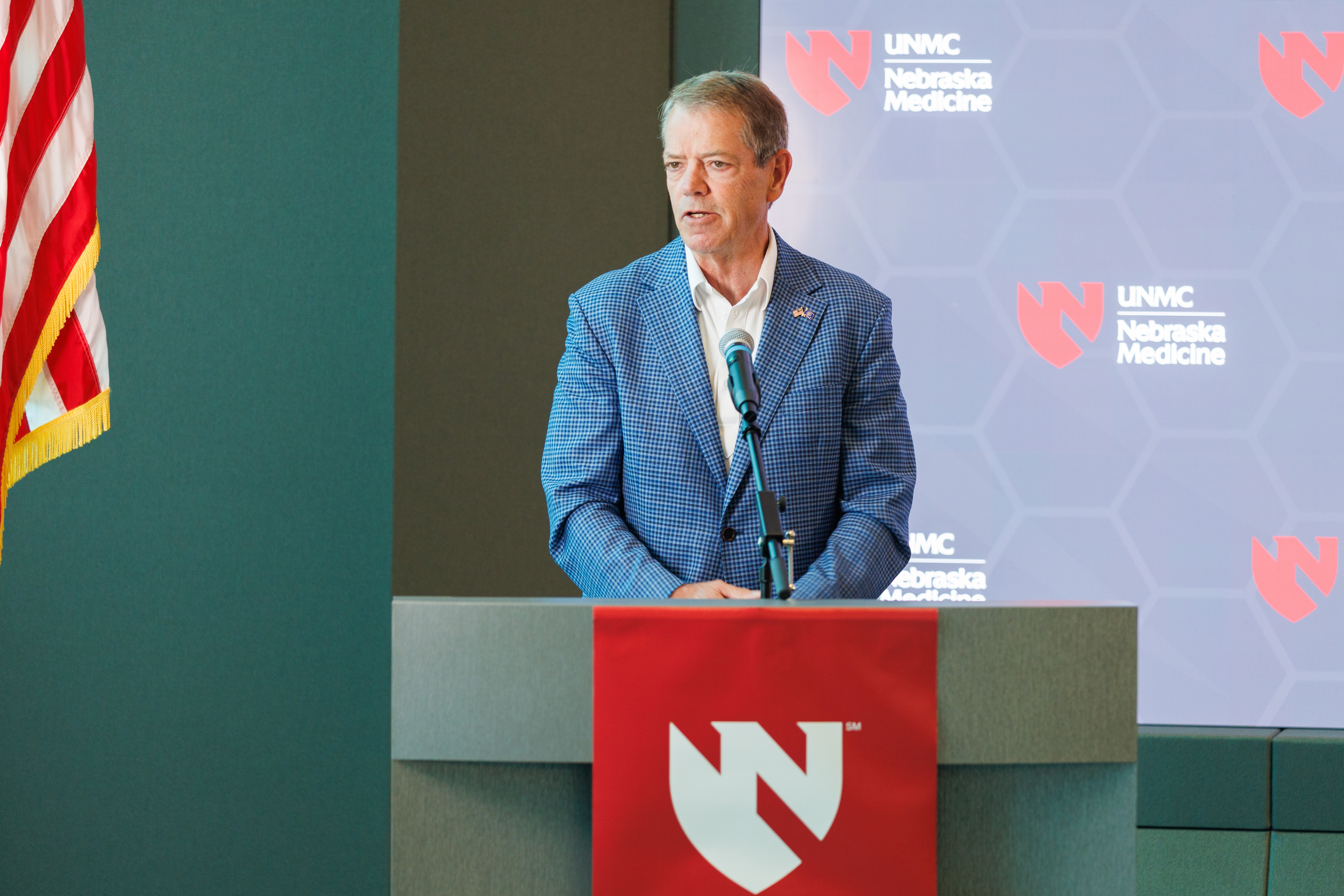 Gov Jim Pillen at a podium at UNMC during a press conference. 