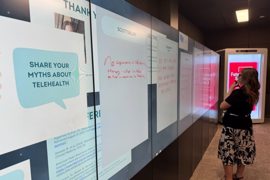Person writing on a large interactive touchwall