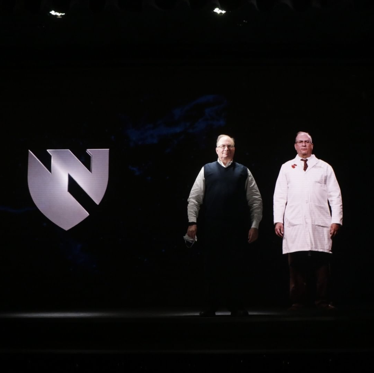 Dr. Robert Norgren stands next to his hologram