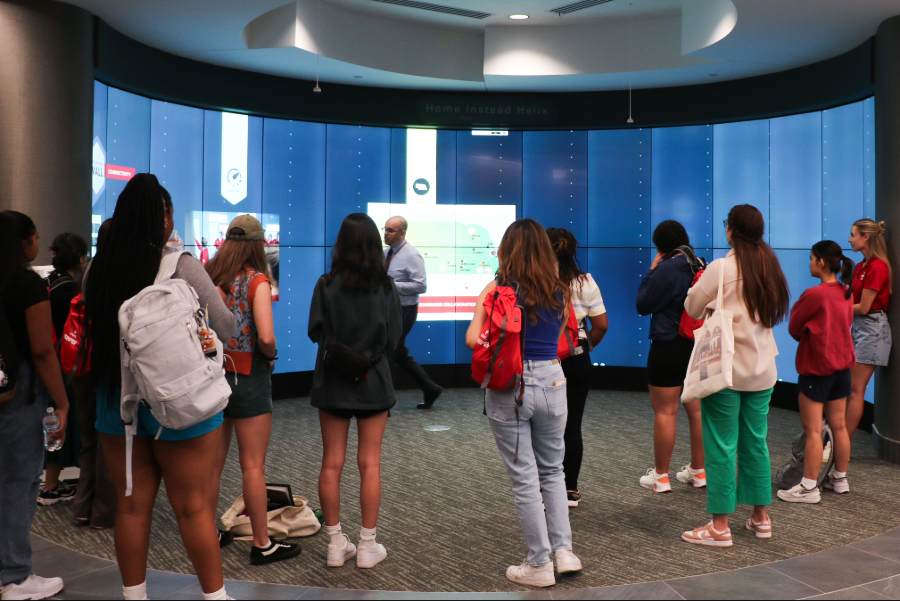 A group of students standing near an iwall