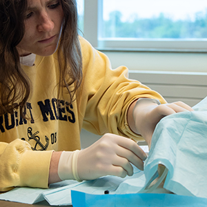 students practicing pediatric lumbar punctures on manikin
