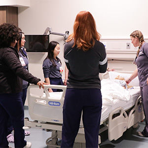 nurses practicing bedside competencies on manikin