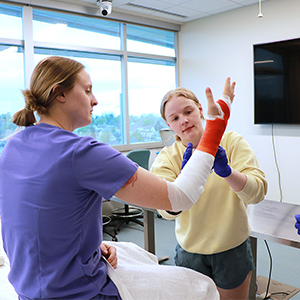 students practicing casting on arm