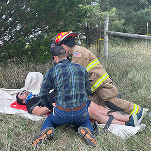 resident and EMS helping simulated patient