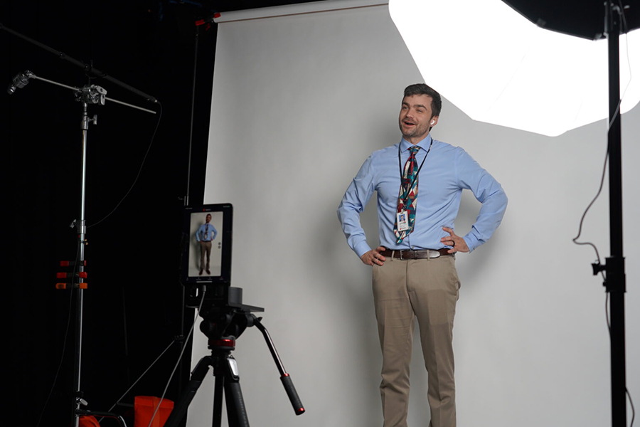Person in front of a white backdrop live streaming to a holo box