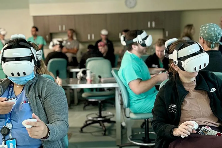 Surgeons at tables wearing head-mounted displays