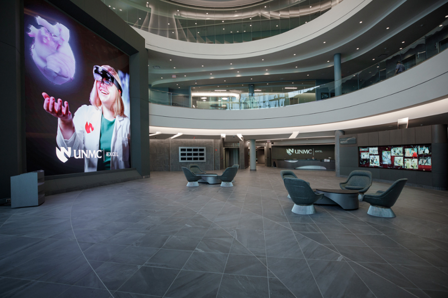 Inside the Davis Global Center atrium with an illustration of the heart on the infinity wall.
