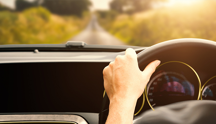 A hand on a steering wheel