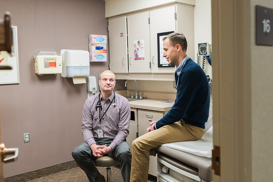 Two faculty members collaborate in a clinic room at UNMC.