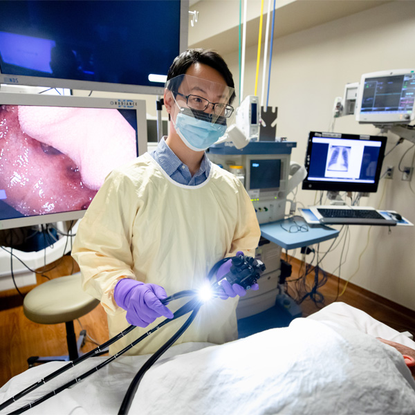 A provider works over a patient in an operating room