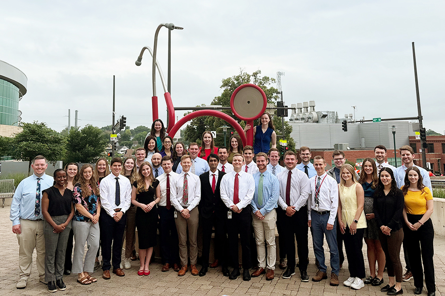 The Internal Medicine first-year house officers on their first day of residency standing in front of the stethoscope sculpture on the UNMC campus.