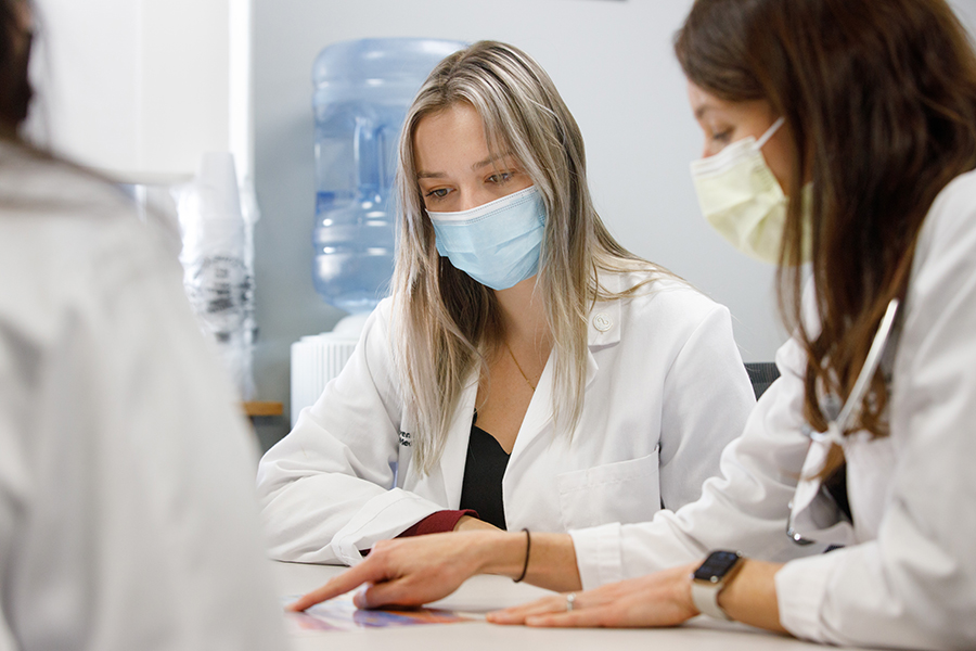 UNMC Internal Medicine trainees working with a faculty member.