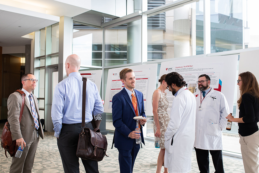 A group of UNMC Internal Medicine faculty and trainees participating in a poster session.