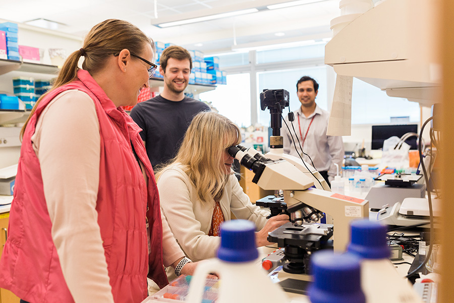 Researchers at UNMC meet in the lab.