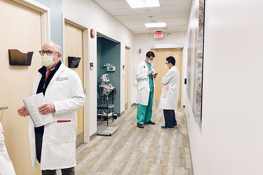A team of physicians talking in the hallway at the Frederick F. Paustian IBD Center at UNMC.