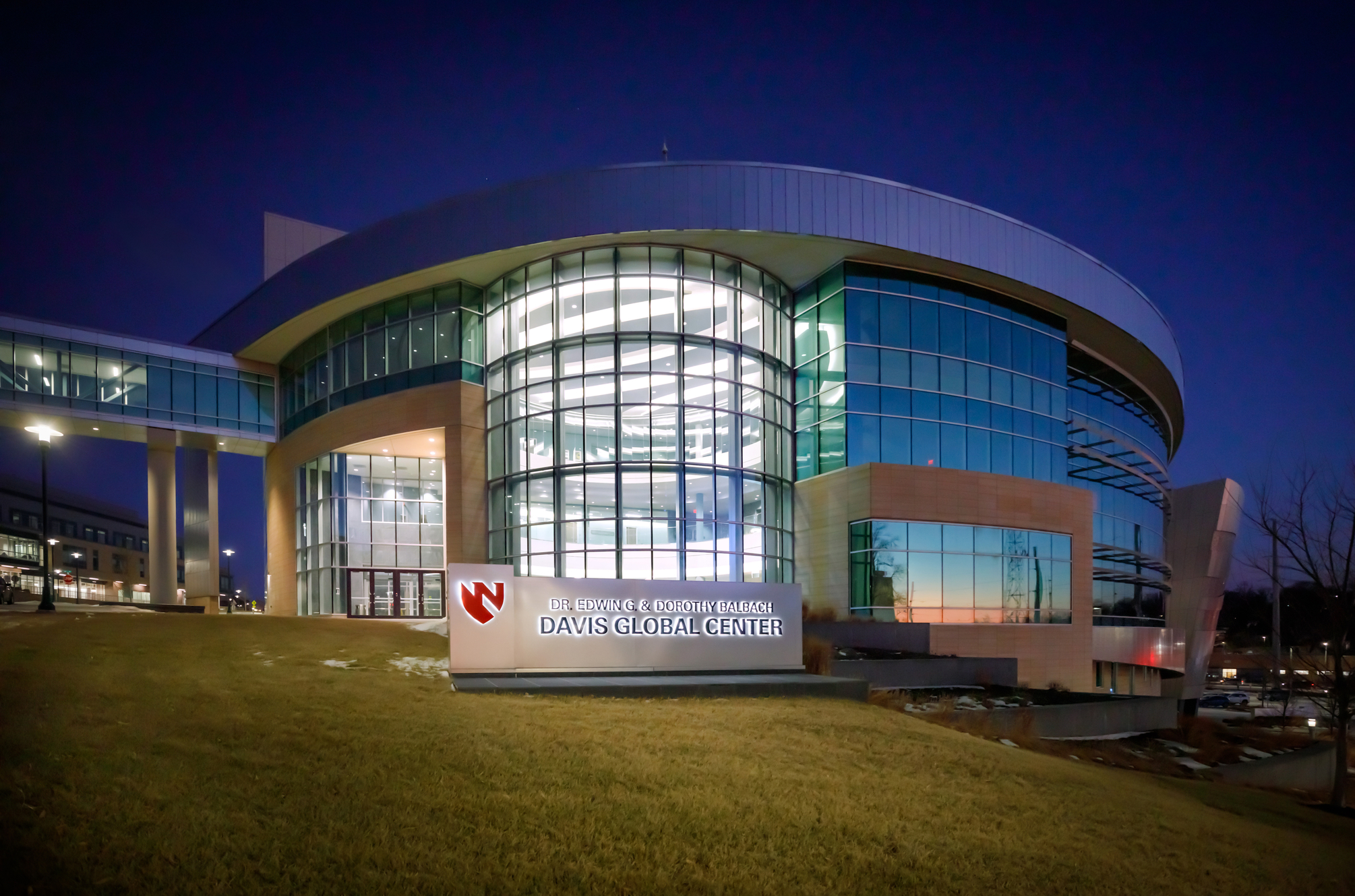 The exterior of the Davis Global Center  building at night.